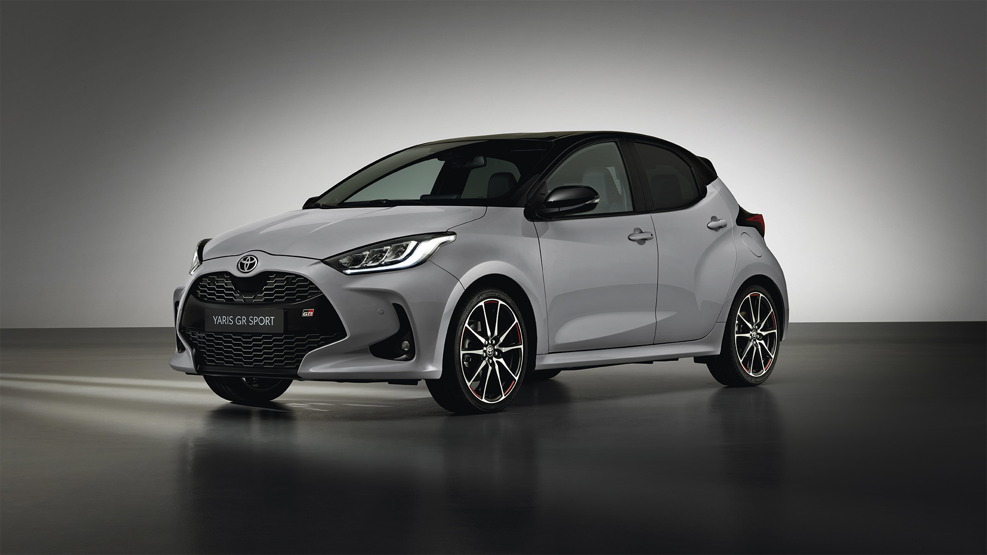 Model shown is Yaris GR SPORT  in bi-tone Dynamic Grey Night Sky Black roof (2RZ) and GR SPORT black fabric with red stitching seat